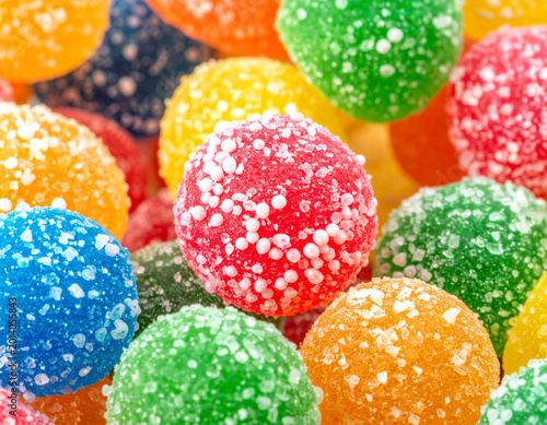 Photograph of a jumbled pile of bright, colorful, sugar coated, fruit flavored candies. Ai