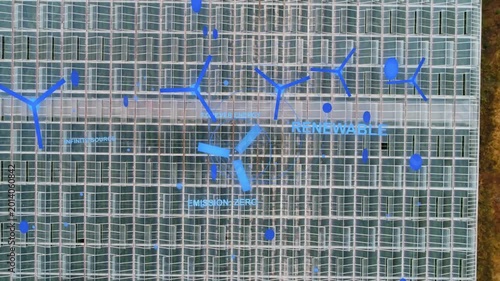 Glass-roof structure with blue overlays appearing camera moving down showing crops for renewables