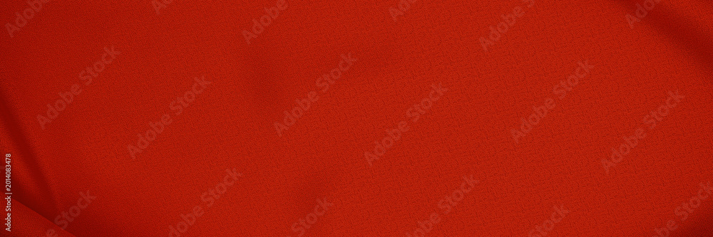 Fototapeta premium Bright red fabric shows texture and color under even lighting in a neutral space