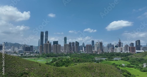 Rural green fields with fish ponds between Hong Kong and skylines of Shenzhen,China