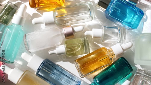 Glass cosmetic bottles with pipette for serum, extract, aromatic, essential oil and emulsion. Cosmetics skincare. Cosmetic spa. Sample of packaging for design, beauty product, advertising. 4k
