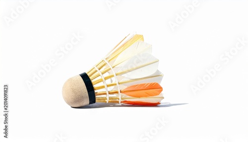 A badminton court with a racket lying on the green floor and shuttlecocks scattered around, under colorful indoor lighting, symbolizing sports practice, activity, and athletic training in progress.