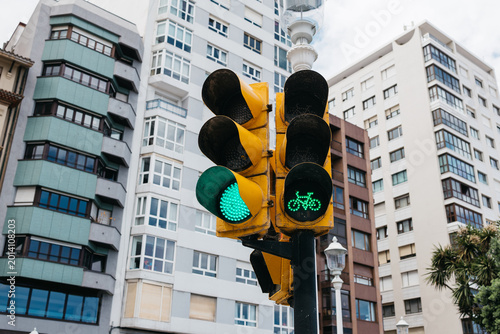 Tablou pe pânză Close-up of a traffic light installed in front of modern buildings, highlighting urban infrastructure and traffic control systems