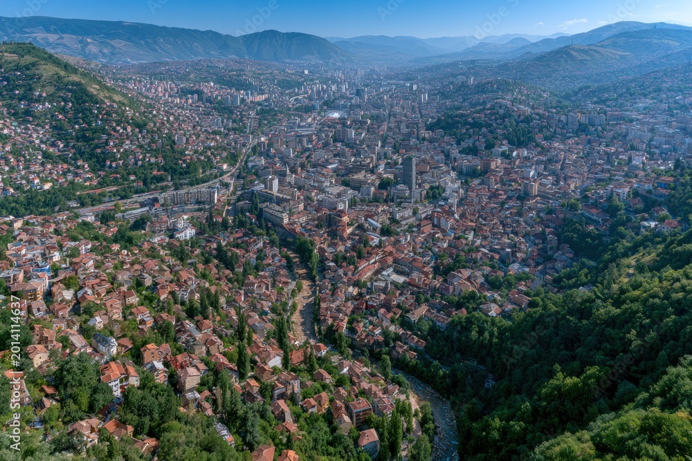 Fototapeta premium Aerial View of a Mountain City with Dense Urban Landscape