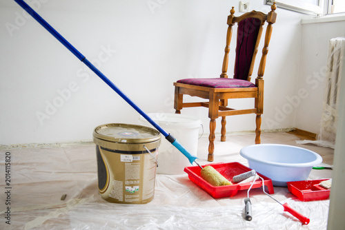 Canvas-taulu Interior Room Prepared for Painting with Tools, Paint Bucket, and Wooden Chair i