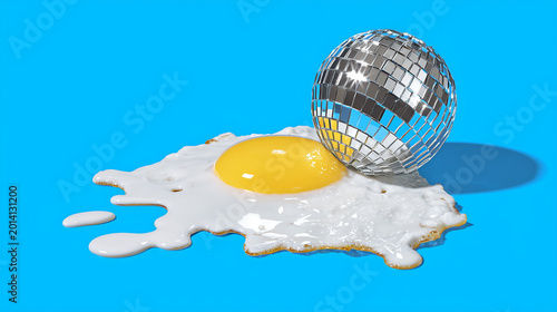 Conceptual fried egg with silver disco ball on bright blue background