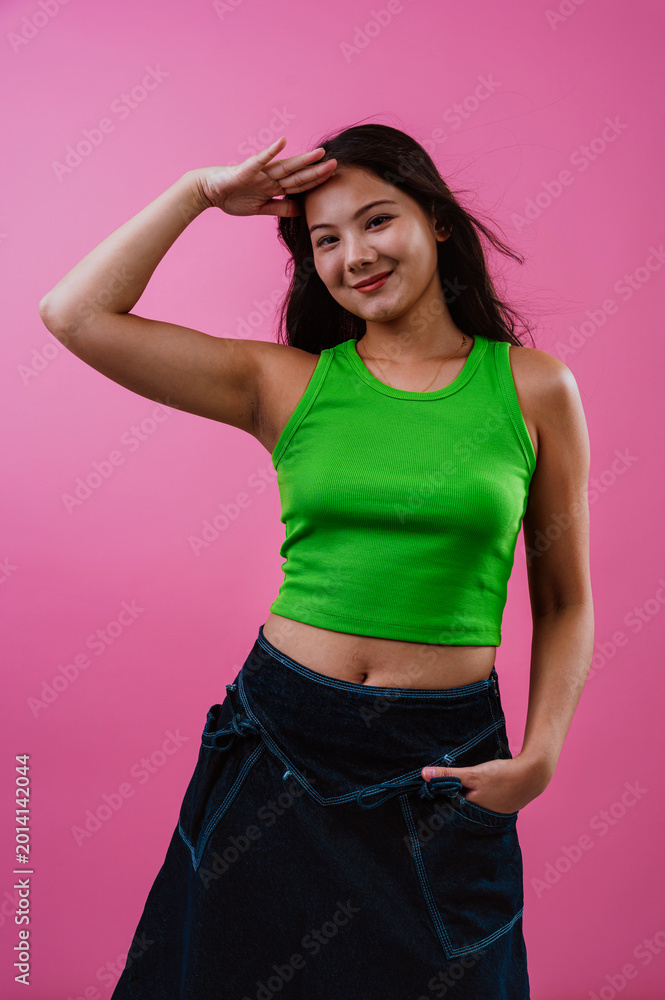 Fototapeta premium Happy young woman dancing with colorful background
