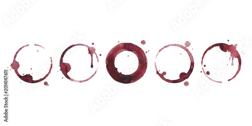 Photos Five red wine glass stains and circular drink rings on a flat surface