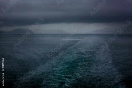 Boat wake behind the San Juan Islands ferry, low cloud and a stormy outlook.