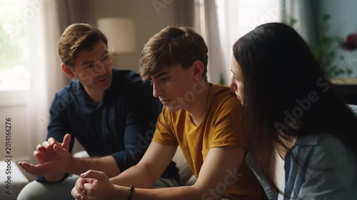 Caring parents consoling their sad teenage son, offering advice and support