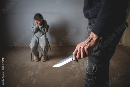 Tableau sur toile Caucasian murderer with a child girl.