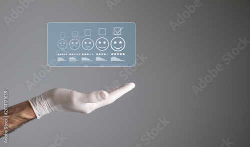 Doctor hand with a patient satisfaction rating. Feedback
