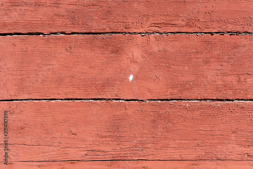 Old barn wood planks with chipped red paint