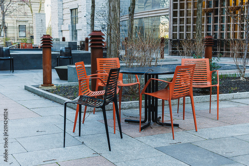 Empty chairs and table at an outdoor area in a city park during a sunny day