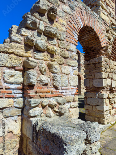Valokuva Old stone ruins stand tall against a clear blue sky in a historic site showing a