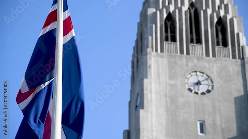 Iceland flag waving to the wind in front of Reykjavik Cathedral, Iceland