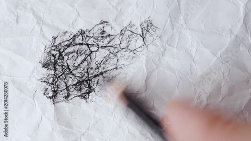 close up of charcoal pencil drawing on textured paper. slow motion footage. Background video can be used as overlay. doodling hatching