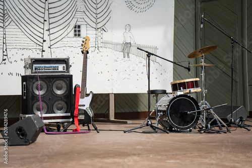 Canvas Print Live music band gear featuring a drum set bass guitar and powerful amplifiers on