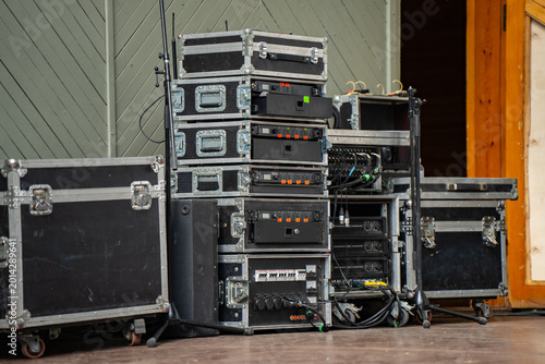 Canvastavla Professional sound equipment and audio rack cases stacked on an outdoor stage fo
