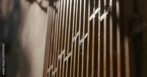 Close-up of a metal gate illuminated by sunlight with shallow depth of field in Zagreb, Croatia.
