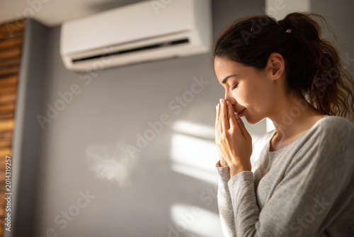 Person covers nose and reacts to an unpleasant odor coming from a cooling outlet