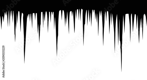 Foto Sharp glistening icicles hang precariously from a dark frosty overhang creating