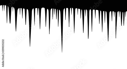 Photography Sharp elongated icicles hang precariously from a dark frosty overhang against a