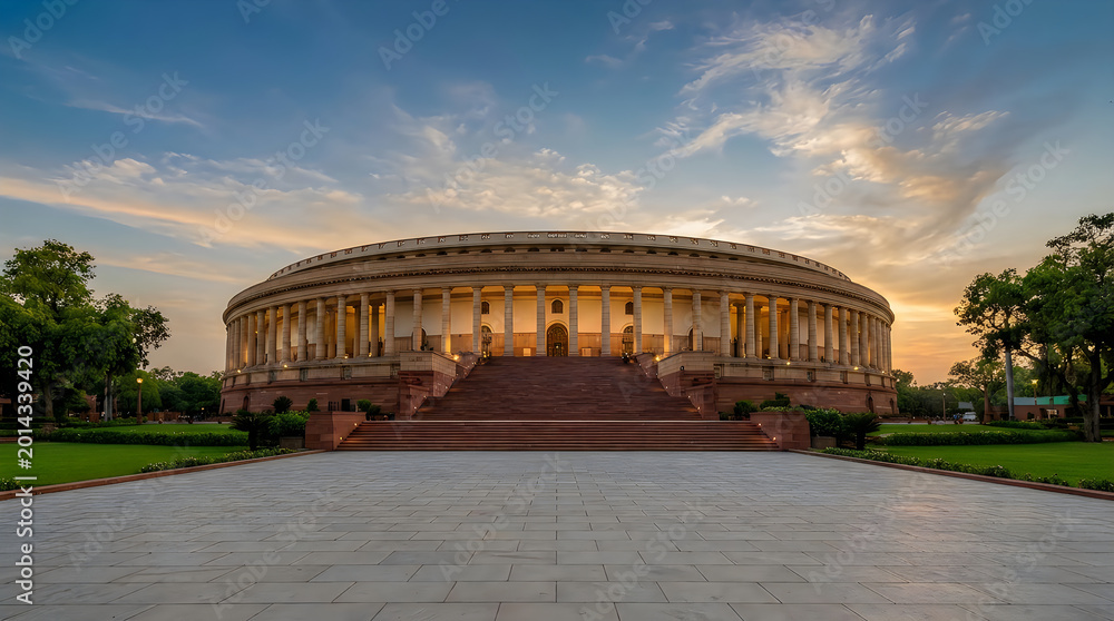 Fototapeta premium Parliament house of india in new delhi at sunset, a historic circular building with grand columns and stone architecture