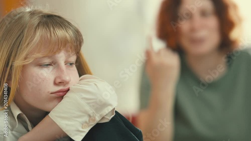 Frustrated teenage girl ignoring her mother during argument