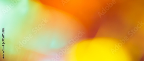 Vibrant abstract background with blurred orange yellow and mint green gradient and soft bokeh