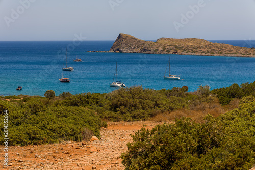 Photography High angle view of a beautiful Mediterranean bay with boats and arid landscape