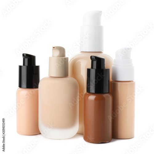Foto Bottles of skin foundations in different shades isolated on white