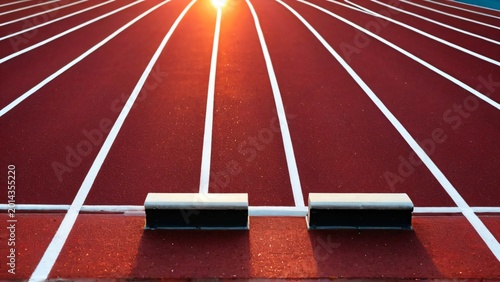 Close-Up of Running Track with Starting Blocks at Sunrise