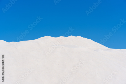 Obraz na plátně White Salt Mounds in Kalloni Salt Pans under Blue Sky, Lesvos, Greece