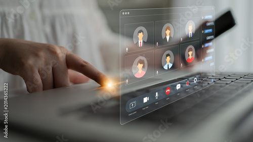 Canvas-taulu Virtual Meeting Interaction With Hand Touching Laptop Keyboard and Participants Displayed on Screen in Modern Workspace Setting