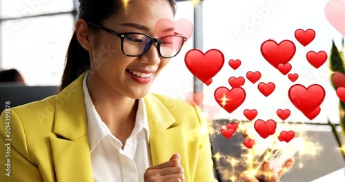 Professional woman smiling while using smartphone with floating red heart icons in modern office setting