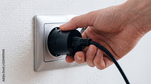 Plugging the power supply into an outlet, wired charging of equipment, mains power, plug and socket