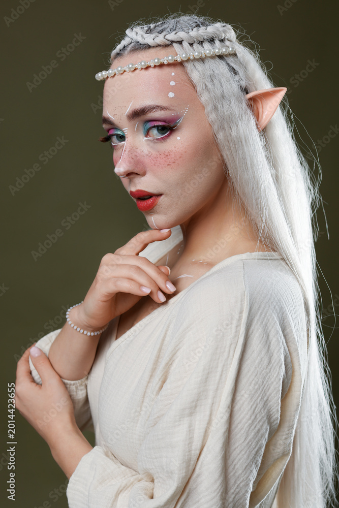 Fototapeta premium Beautiful elf girl on dark olive background
