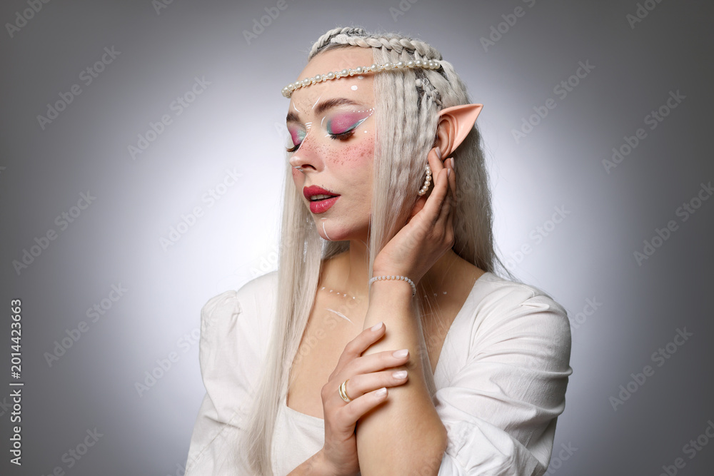 Fototapeta premium Beautiful elf girl on grey gradient background