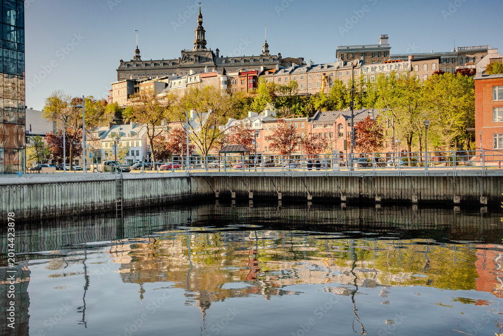 Fototapeta premium Old Quebec City Waterfront with Historic Buildings and Reflection in Autumn Canada
