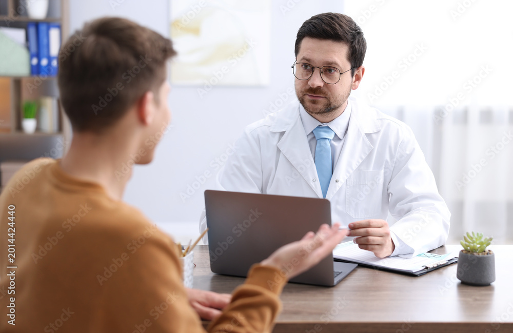 Fototapeta premium Man having appointment with doctor in clinic, selective focus