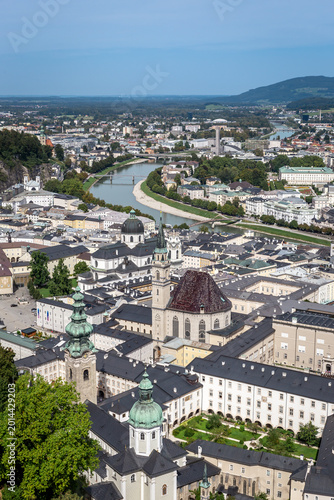Salzburg showcases its buildings, cathedral and river under a clear sky. A stunning view of the city from above invites exploration.