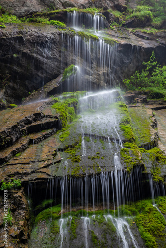A view of a waterfall cascading down rocks in Wimbachklamm, a popular travel spot in Ramsau, Germany.