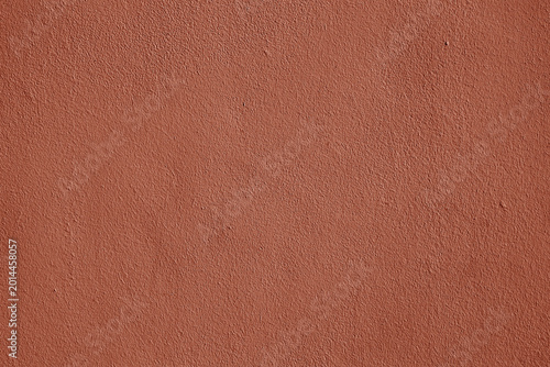 Coral stucco wall texture, peach fuzz color background. Abstract grunge artistic backdrop for design. Salmon color ribbed paper, pastel pink plaster, pattern.