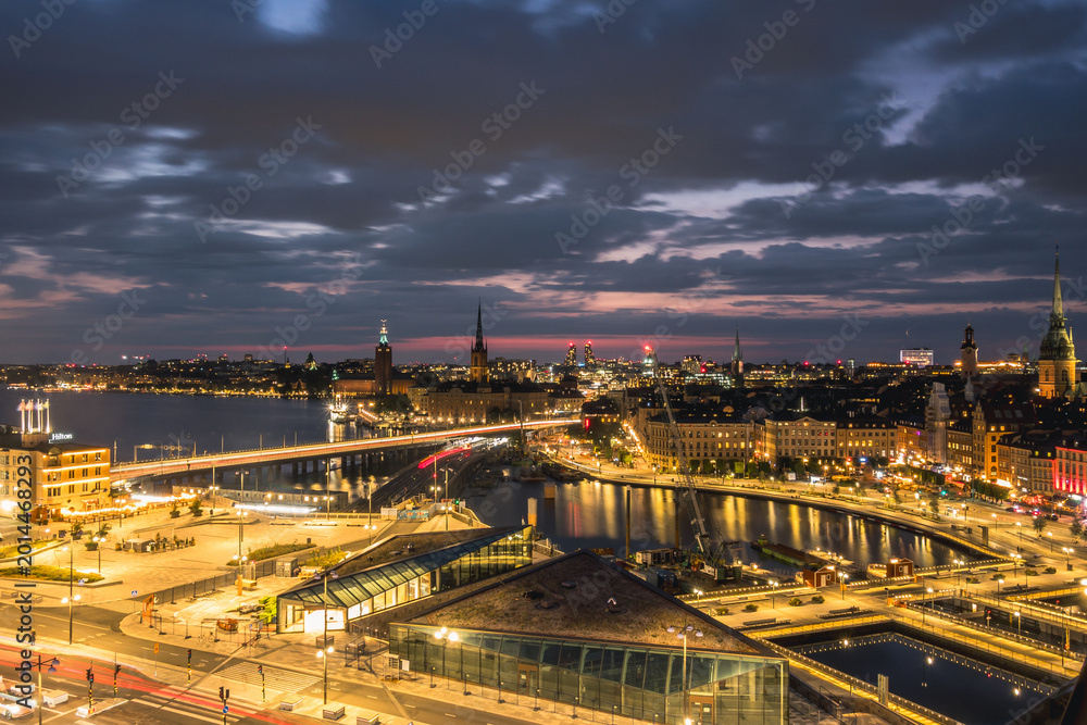 Fototapeta premium Stockholm Sweden Skyline with City Hall Stadshuset and Riddarholmen Church at Sunset with Bridges and Waterfront Cityscape