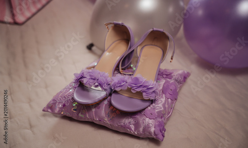 Photos purple women's sneakers on top of a pillow