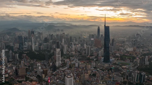Aerial view time lapse 4k video of Kuala Lumpur city center view during dawn overlooking the city skyline in Federal Territory, Malaysia. Tilt up