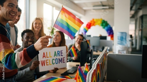 Diverse Young Professionals Celebrating LGBTQ Pride Month in Modern Office Workplace with Rainbow Flags and Inclusion Sign