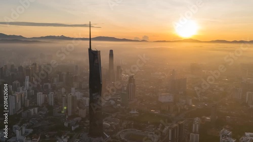 Aerial view time lapse 4k video of Kuala Lumpur city center view during dawn overlooking the city skyline in Federal Territory, Malaysia. Pan right