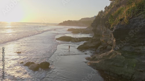 Aerial Serenity A Solitary Walk Along El Salvadors Golden Coastline at Dusk